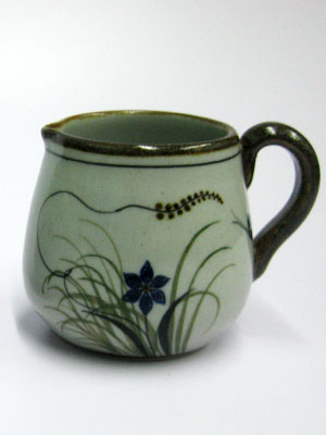 Butterfly Dinnerware / 'Brown Rim Butterfly' Creamer / Ideal for a midday coffee or tea with friends, this creamer is adorned with a butterfly, flowers and grass bordered with a brown rim.